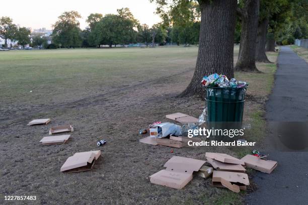 After a late-night party by park-users during the Coronavirus pandemic, litter and waste is strewn across the grass in Ruskin Park, on 30th July...