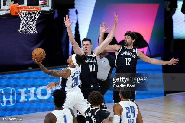 Markelle Fultz of the Orlando Magic heads to the basket as Rodions Kurucs and Joe Harris of the Brooklyn Nets defend during the first half on July...