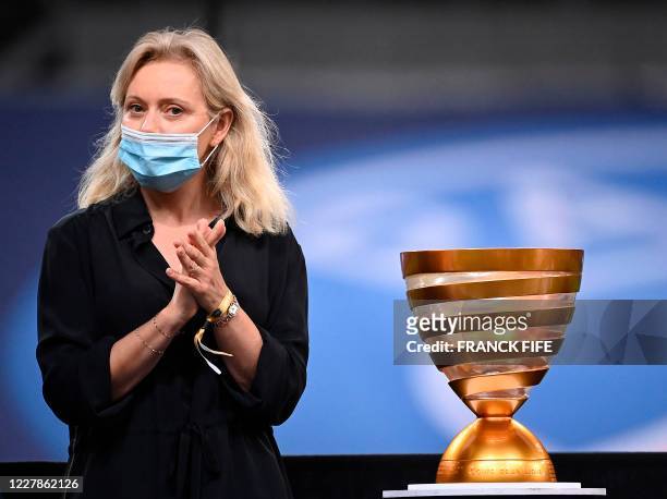 President of the Professional Football League Nathalie Boy de la Tour applauds past the French League Cup trophy at the end of the French League Cup...