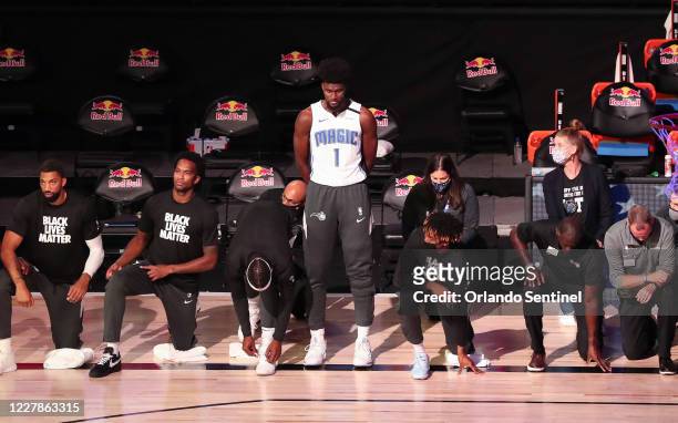 Orlando Magic forward Jonathan Isaac is the lone player to stand and not wear a "Black Lives Matter" t-shirt prior to a game against the Brooklyn...