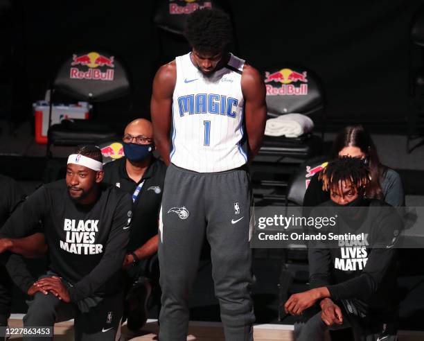 Orlando Magic forward Jonathan Isaac is the lone player to stand and not wear a "Black Lives Matter" t-shirt prior to a game against the Brooklyn...