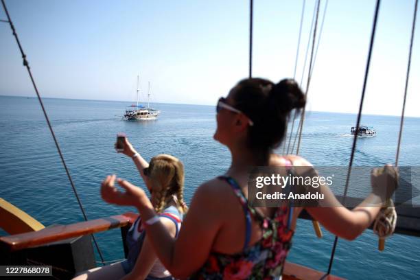 Yachting boats are seen for a day tour of blue voyage to tour around bays of Kemer district during summer season in Antalya, Turkey on July 29, 2020....