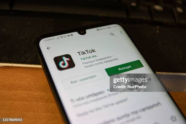 TikTok closeup logo displayed on a phone screen, smartphone and keyboard are seen in this multiple exposure illustration. Tik Tok is a Chinese...