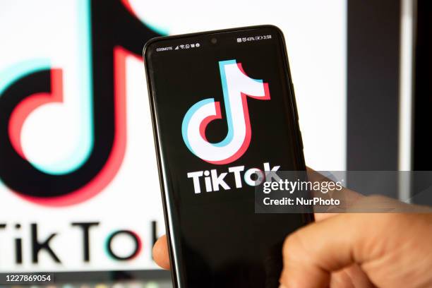 TikTok closeup logo displayed on a phone screen, smartphone and keyboard are seen in this multiple exposure illustration. Tik Tok is a Chinese...