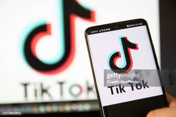 TikTok closeup logo displayed on a phone screen, smartphone and keyboard are seen in this multiple exposure illustration. Tik Tok is a Chinese...