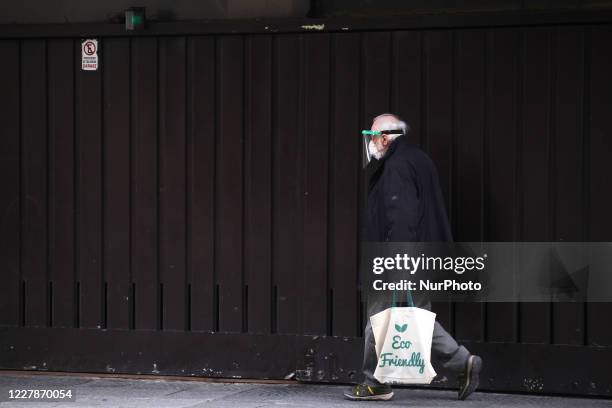 Man wearing a protective mask walks in Buenos Aries, Argentina on August 1, 2020. The City of Buenos Aires will continue in phase 3 of the COVID-19...