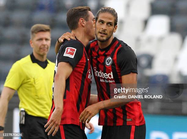 Frankfurt's Portuguese forward Goncalo Paciencia celebrates scoring the 1-0 with a teammate during the friendly football match between German first...