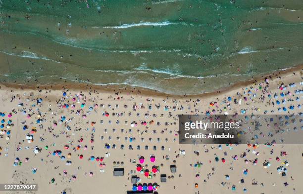 Drone photo shows the crowd sunbathing and swimming at a beach during the third day of Eid Al-Adha in Sile district of Istanbul, Turkey on August 02,...