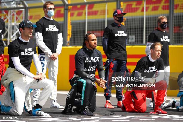 Mercedes' British driver Lewis Hamilton and fellow drivers make a statement on the track as they 'take a knee' in support of the Black Lives Matter...