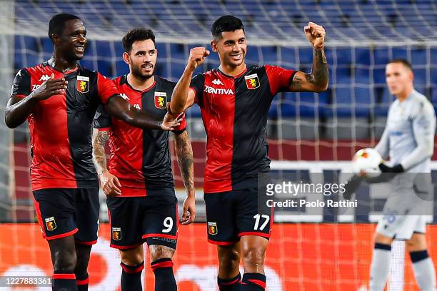 Cristian Romero of Genoa celebrates with his team-mates Cristian Zapata and Antonio Sanabria after scoring a goal during the Serie A match between...