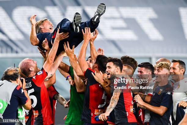 Davide Nicola coach of Genoa is lifted up by his players in celebration after the Serie A match between Genoa CFC and Hellas Verona at Stadio Luigi...