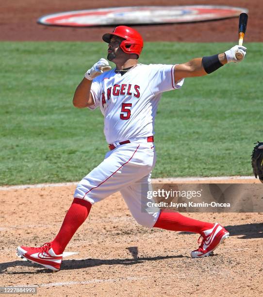 Albert Pujols of the Los Angeles Angels hits a grand slam home run in the third inning of the game against the Houston Astros at Angel Stadium of...