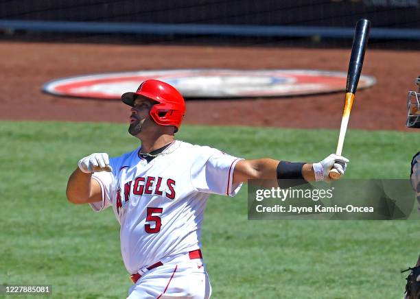 Albert Pujols of the Los Angeles Angels hits a grand slam home run in the third inning of the game against the Houston Astros at Angel Stadium of...