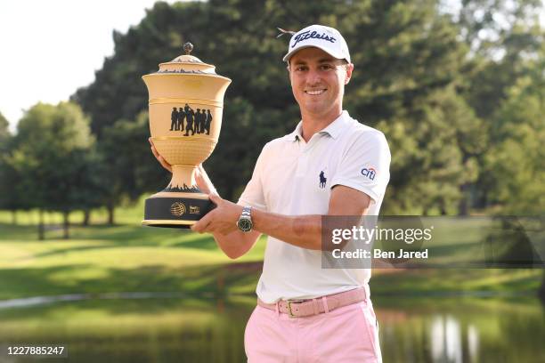 Justin Thomas holds the trophy on the ninth green during the final round of the World Golf Championships-FedEx St. Jude Invitational at TPC Southwind...