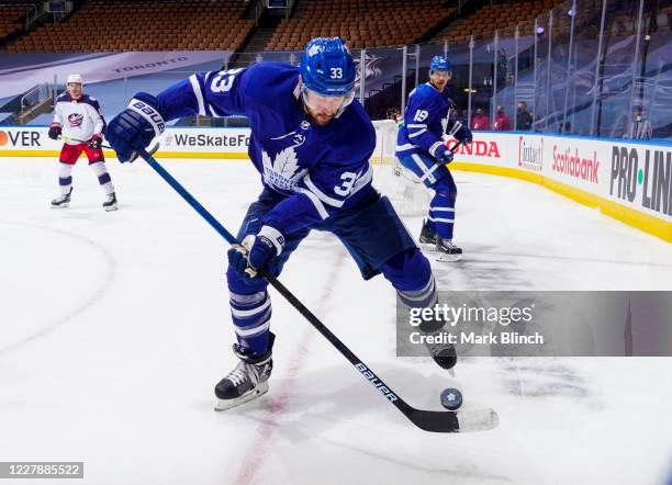 Frederik Gauthier of the Toronto Maple Leafs plays the puck against the Columbus Blue Jackets during the first period in Game One of the Eastern...