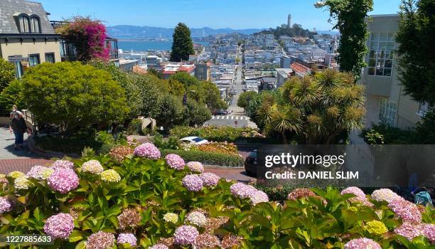 View of Lombard Street famous for a steep, one-block section with eight hairpin turns in San Francisco, California on August 2, 2020 amid the...