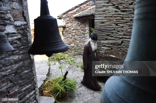 Brother Jean, a former French fashion photographer who became an Orthodox monk, walks in the Skite Sainte Foy monastery on July 29 in...