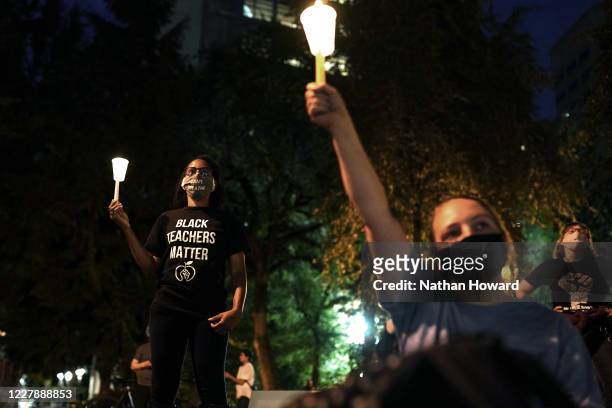 Protesters hold a candlelight vigil in Chapman Square during a Black Lives Matter protest on August 2, 2020 in Portland, Oregon. Portlands nightly...
