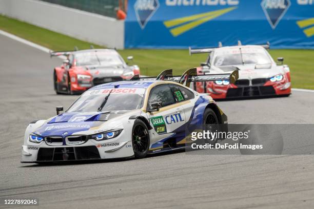 Jonathan Aberdein of South Africa for the BMW Team RMR drives his BMW M4 DTM ahead of Robert Kubica of Poland for the Team Art Grand Prix drives his...
