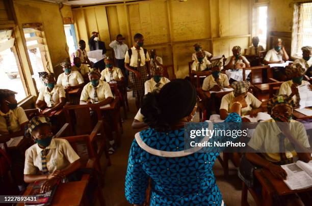 Teacher gives a lesson to students at Girls Junior Grammar School, S.W, Ikoyi, Lagos on August 3, 2020 on the first day after resumption of classes...