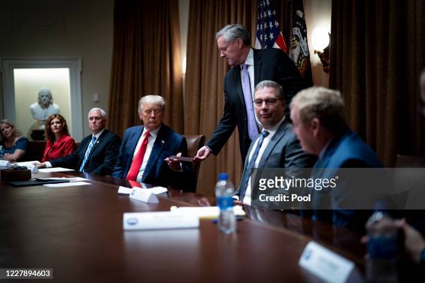 White House Chief of Staff Mark Meadows hands President Donald Trump a note saying that he had just spoken with the TVA CEO and he indicated he would...