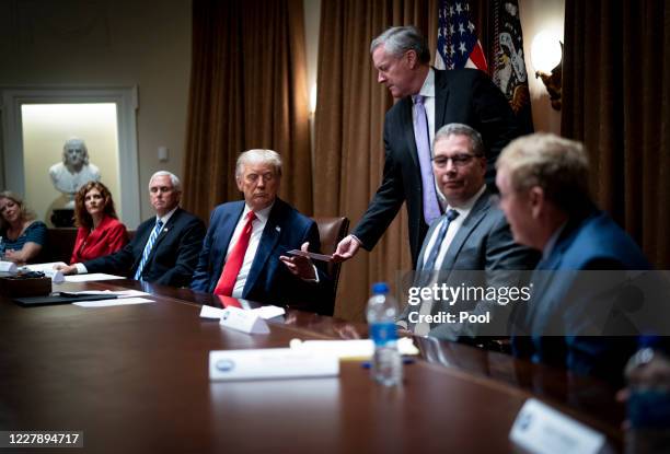 White House Chief of Staff Mark Meadows hands President Donald Trump a note saying that he had just spoken with the TVA CEO and he indicated he would...