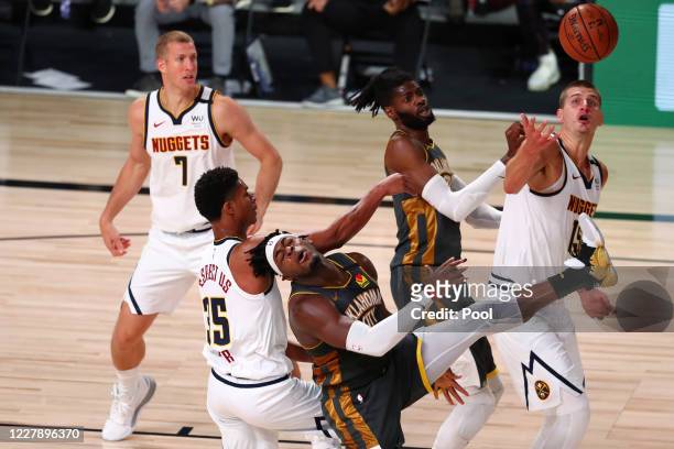 Dozier of the Denver Nuggets fouls Luguentz Dort of the Oklahoma City Thunder during the third quarter in a NBA basketball game at The Arena at ESPN...