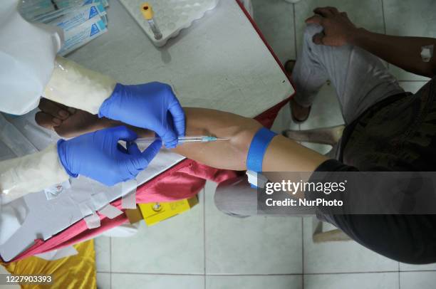 Health medical personnel from the local area conduct Rapid tests on scavengers and poor people at the location where they live in Kampung Sumur,...