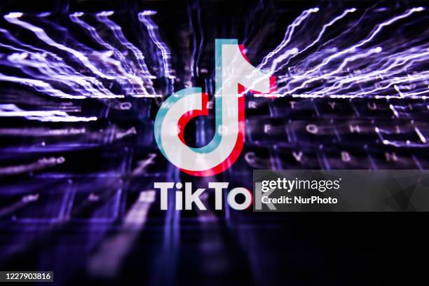 TikTok logo displayed on a screen and keyboard are seen in this multiple exposure illustration photo taken on August 3, 2020. Microsoft is interested...