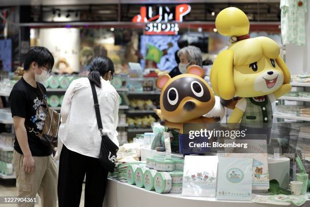 Figurines of the characters Isabelle, right, and Tom Nook from the Nintendo Co. Video game Animal Crossing: New Horizons are displayed inside the...