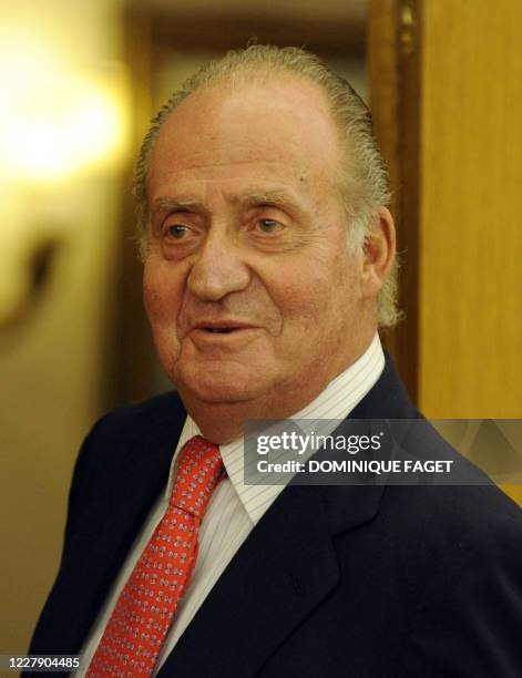 Spain's King Juan Carlos talks to the press before welcoming Colombian President-elect Juan Manuel Santos at the Zarzuela Palace in Madrid on July...