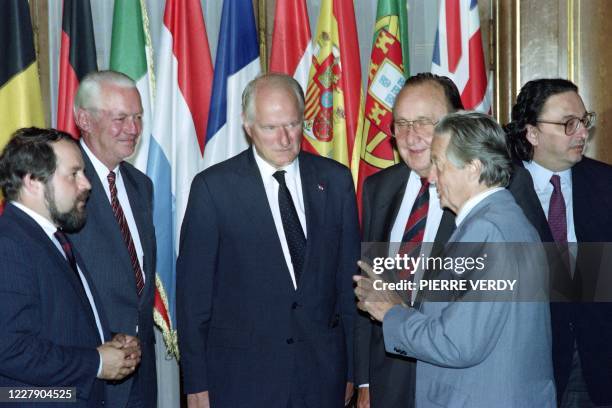 French Foreign Affairs Minister Roland Dumas speaks with his counterparts Hans-Dietrich Genscher of West Germany , Gianni de Michelis of Italy , Jao...