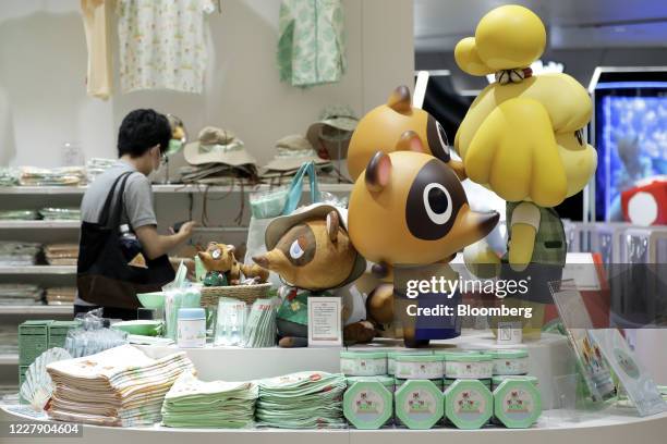 Figurines and plush toys of characters from the Nintendo Co. Video game Animal Crossing: New Horizons are displayed inside the Nintendo TOKYO store...