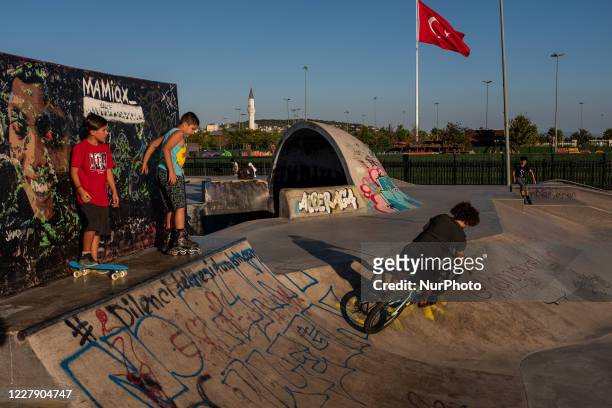 Teenagers skate and perform tricks at a local skatepark in Istanbul, Turkey on August 3, 2020 during the Eid al-Adha holiday.