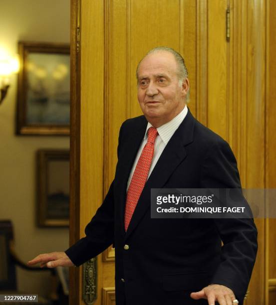 Spain's King Juan Carlos talks to the press before welcoming Colombian President-elect Juan Manuel Santos at the Zarzuela Palace in Madrid on July...