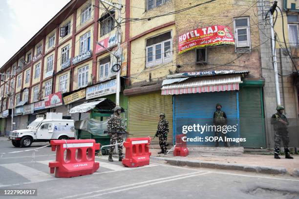 Paramilitary troopers stand on guard during a strict curfew in Kashmir. Barricades have been set up at hundreds of places in Kashmir, including...