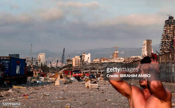 Man reacts at the scene of an explosion at the port in Lebanon's capital Beirut on August 4, 2020. - Two huge explosion rocked the Lebanese capital...
