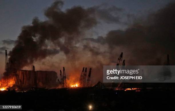 This picture taken on August 4, 2020 shows a view of the port of Lebanon's capital Beirut with its cranes in the aftermath of a massive explosion. -...