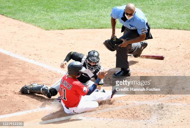 John Ryan Murphy of the Pittsburgh Pirates defends home plate from Jorge Polanco of the Minnesota Twins as umpire CB Bucknor looks on during the...
