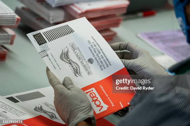 An elections worker opens ballots at the King County Elections headquarters on August 4, 2020 in Renton, Washington. Today is election day for the...