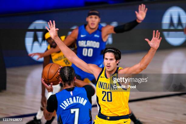 Doug McDermott of the Indiana Pacers defends against Michael Carter-Williams of the Orlando Magic during the first half of an NBA basketball game on...