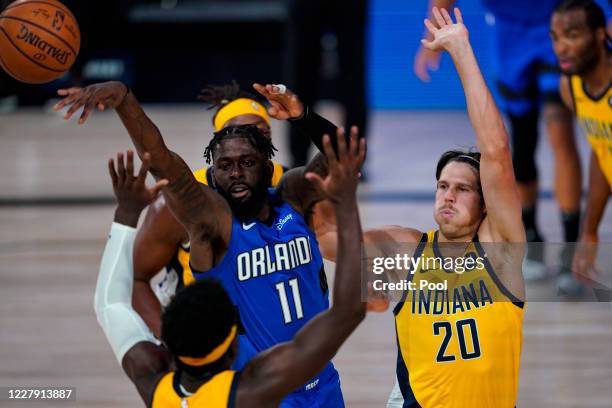 James Ennis III of the Orlando Magic passes against Doug McDermott of the Indiana Pacers during the second half at Visa Athletic Center at ESPN Wide...