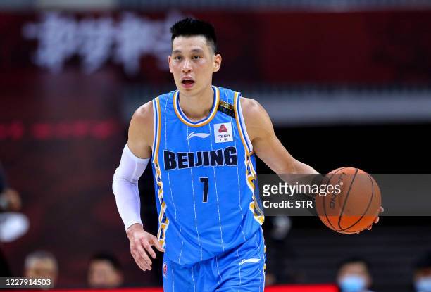 This photo taken on August 4, 2020 shows Beijing Ducks' Jeremy Lin driving the ball during the Chinese Basketball Association match between Beijing...