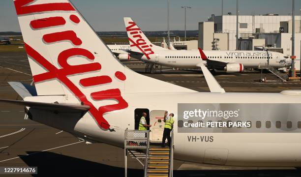 Virgin Australia planes are seen at Sydney airport on August 5, 2020. - Pandemic-struck airline Virgin Australia announced on August 5 it would close...