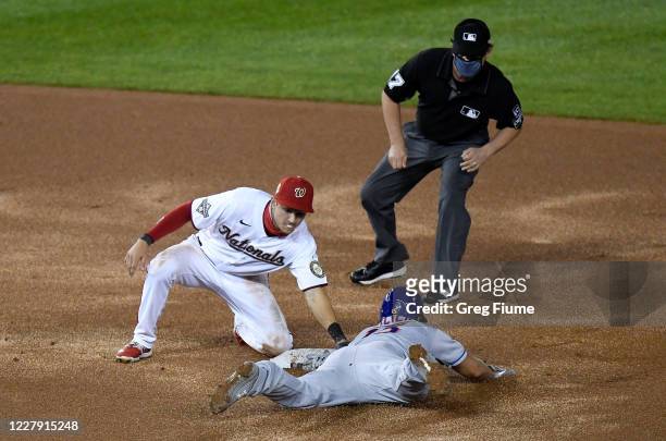 Brian Dozier of the New York Mets is tagged out trying to steal second base in the eighth inning by Trea Turner of the Washington Nationals at...