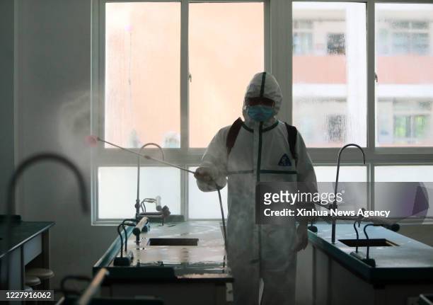 Aug. 3, 2020 -- A fireman disinfects a lab of Wuhan No. 3 Boarding School in Hanyang District of Wuhan City, central China's Hubei Province, Aug. 3,...