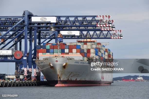 This photo taken on August 4, 2020 shows a container ship getting loaded at the main Botany port in Sydney. The Australian government has stumped up...