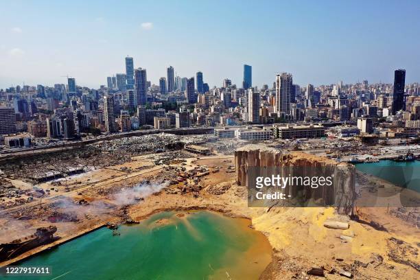 An aerial view shows the massive damage at Beirut port's grain silos and the area around it on August 5 one day after a massive explosion hit the...