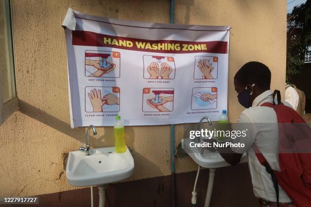 Final year student of Agidingbi Senior Grammar School, Ikeja, Lagos, Nigeria washes his hands as schools resume after COVID-19 lockdown order on...