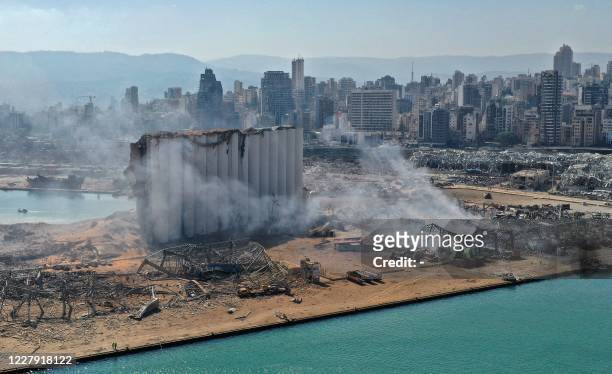 An aerial view shows the massive damage done to Beirut port's grain silos and the area around it on August 5 one day after a mega-blast tore through...